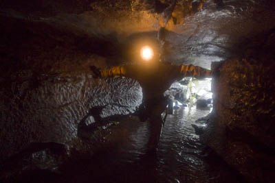 A caver enters Upper Long Churn Cave