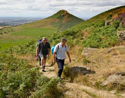Walkers on the Cleveland Way, with Roseberry Topping in the background. Photo: Mike Kipling