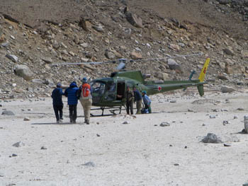 Jacqui's father is helped to the waiting helicopter