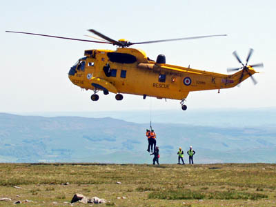 Rescuers are winched from the RAF Sea King on to the summit of Ingleborough. Photo: Trevor Brooks