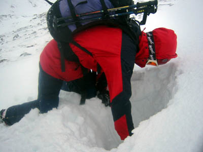 Digging a snow pit to assess avalanche risk in the Highlands
