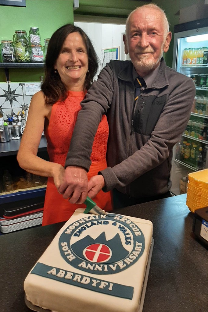 Team secretary Siân Campion cuts a cake with team chair and longest serving member Dave Williams, who joined in 1974