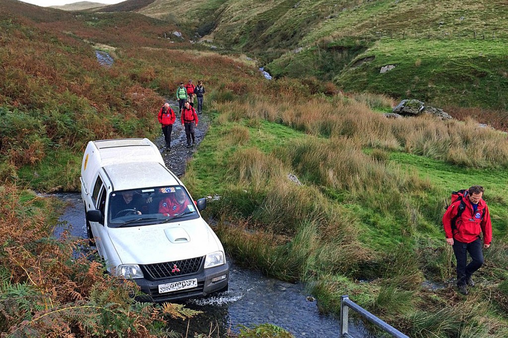 Team members escort the 4x4 vehicle bringing the injured girl from the hill. Photo: Aberdyfi SRT