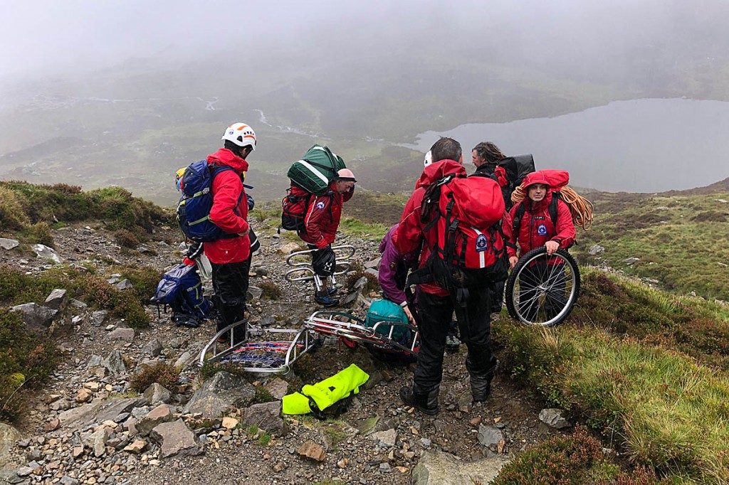 Rescuers await the arrival of the helicopter on the Foxes Path. Photo: Aberdyfi SRT