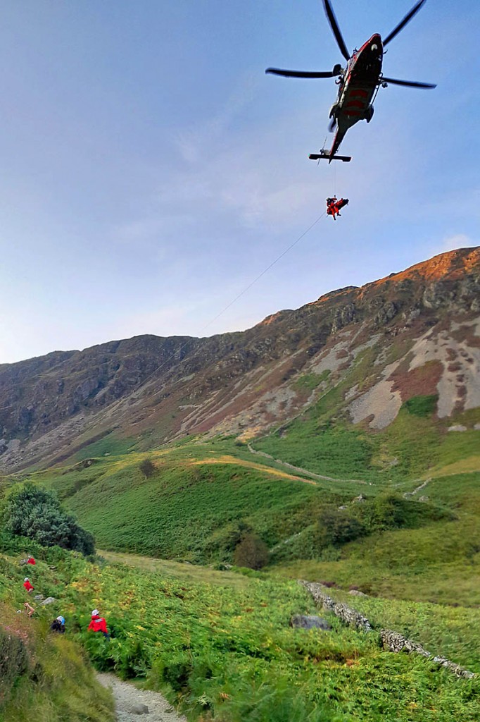 The Coastguard helicopter crew winches the injured walker into the aircraft. Photo: Aberdyfi SRT The Coastguard helicopter crew winches the injured walker into the aircraft. Photo: Aberdyfi SRT