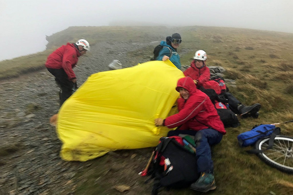 Rescuers contend with high winds while tending to the injured walker. Photo: Aberdyfi SRT Rescuers contend with high winds while tending to the injured walker. Photo: Aberdyfi SRT