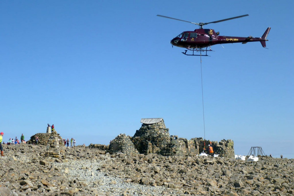 A helicopter lifts materials on to the summit during the restoration work. Photo: John Muir Trust