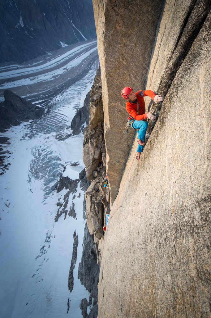 Leo Houlding climbing on a perfect crack right above the Arctic Hotel (Camp 2), as the glacier stretches for miles down on the valley floor. Photo: Matt Pycroft/Coldhouse Collective