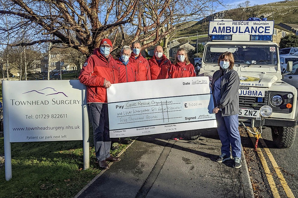 Volunteer rescue team members receive a cheque from the GPs' alliance