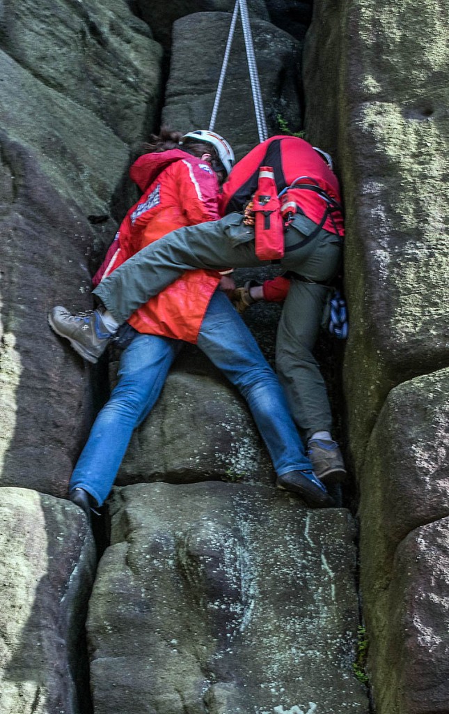A rescuer with the climber at the scene. Photo: Calder Valley SRT A rescuer with the climber at the scene. Photo: Calder Valley SRT