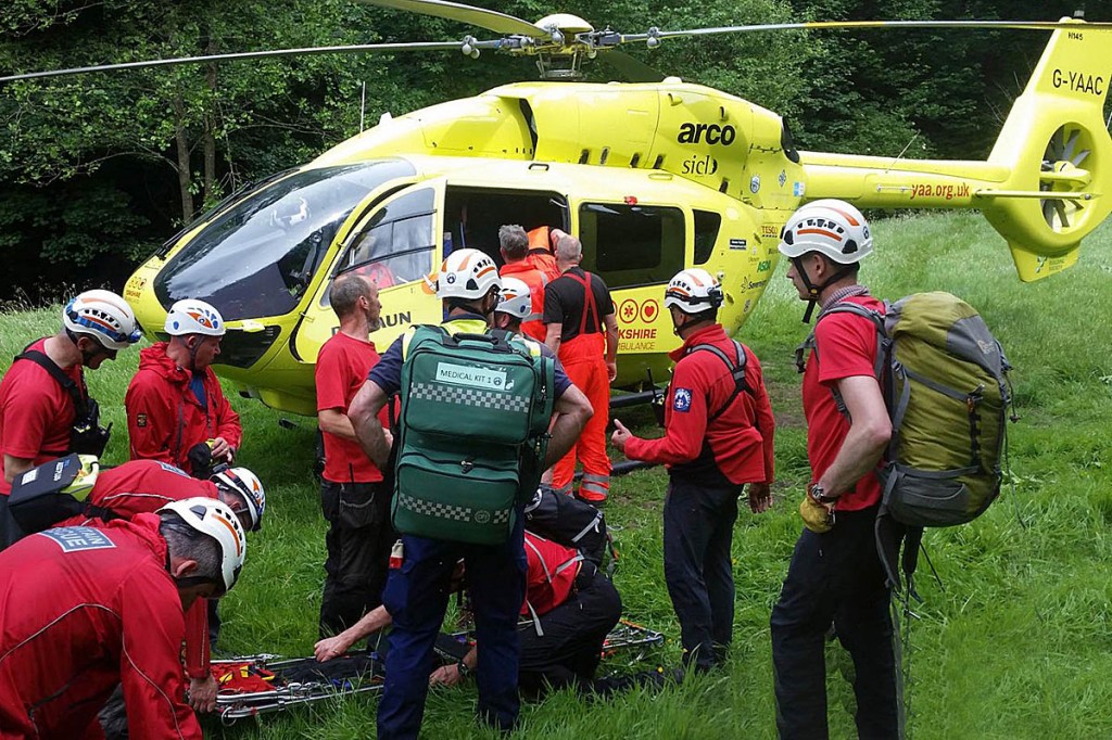 Rescuers with the air ambulance at the scene. Photo: Calder Valley SRT Rescuers with the air ambulance at the scene. Photo: Calder Valley SRT