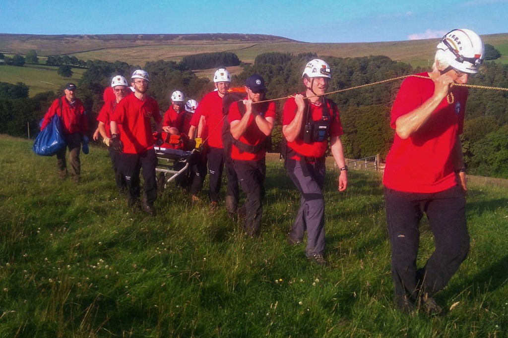 Team members stretcher the injured walker from the scene. Photo: Calder Valley SRT