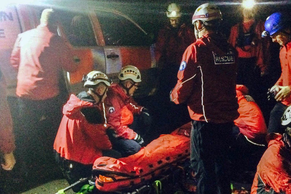 Team members with the injured cyclist at Lumb Bank. Photo: Calder Valley SRT Team members with the injured cyclist at Lumb Bank. Photo: Calder Valley SRT