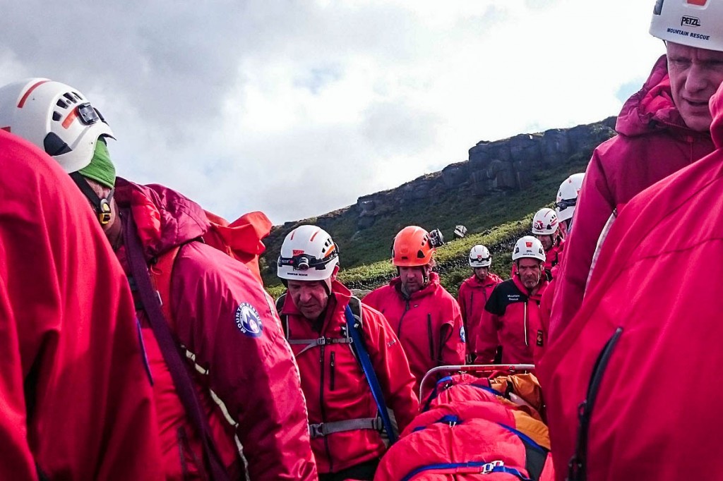 Rescuers stretcher the injured woman from the crag. Photo: Calder Valley SRT Rescuers stretcher the injured woman from the crag. Photo: Calder Valley SRT