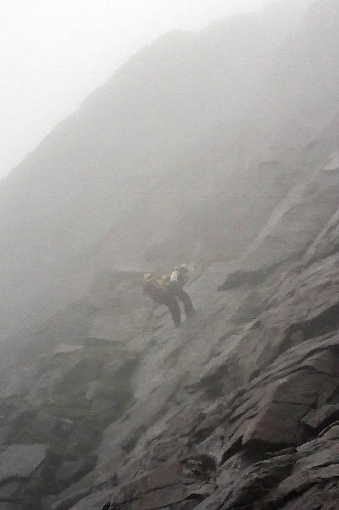 Dr Duncan Scott of the Cairngorm team descends the ridge with the injured climber. Photo: Cairngorm MRT