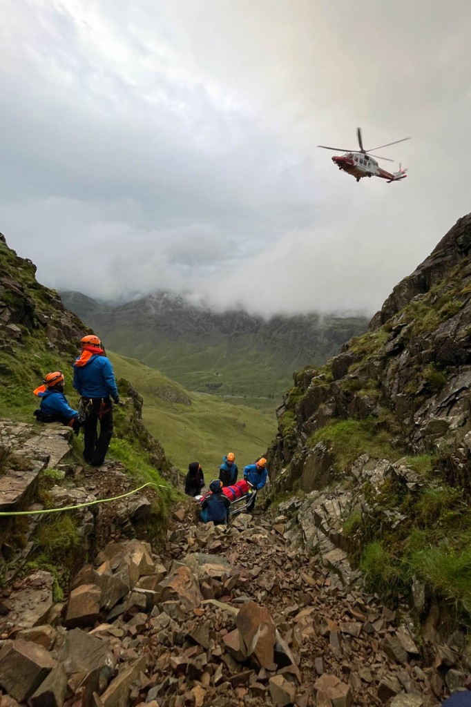 Rescuers and the Coastguard helicopter at the scene in the gully on Kirk Fell. Photo: Cockermouth MRT
