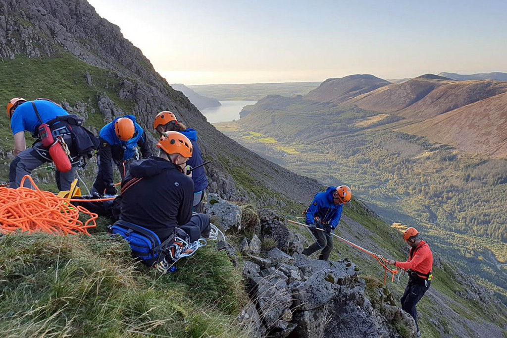 A rescuer is lowered down the crag. Photo: Cockermouth MRT