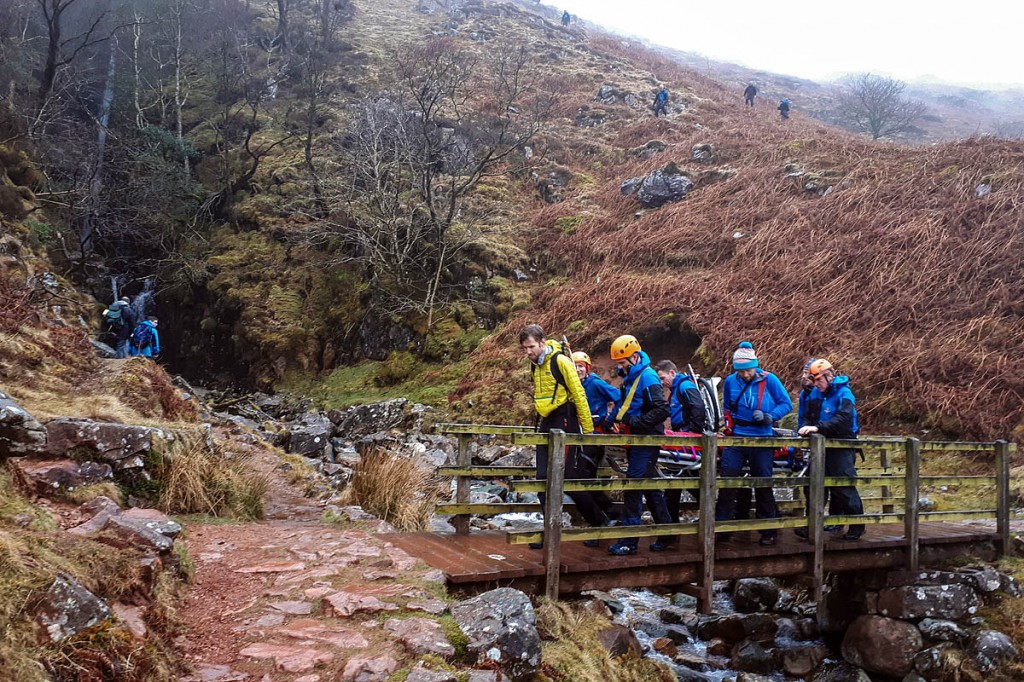 Team members stretcher the injured walker from the fell. Photo: Cockermouth MRT Team members stretcher the injured walker from the fell. Photo: Cockermouth MRT