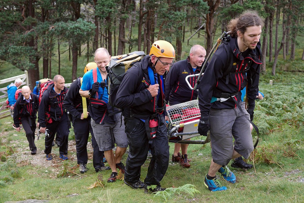 Rescuers stretcher the injured walker to the Land Rover. Photo: Cockermouth MRT