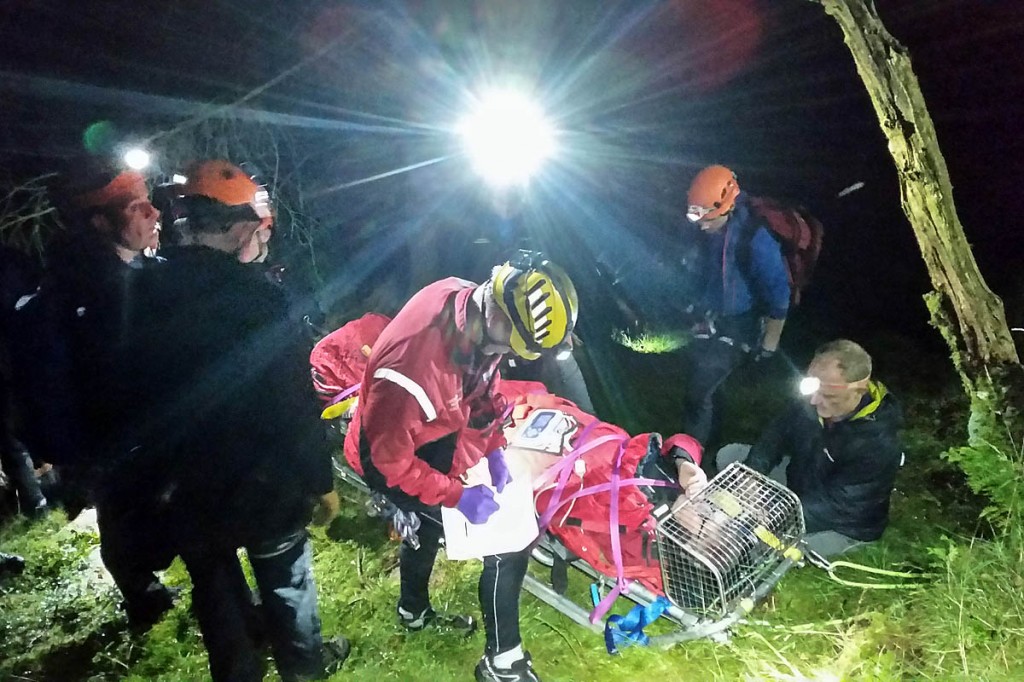 Rescuers with the injured walker. Photo: Cockermouth MRT