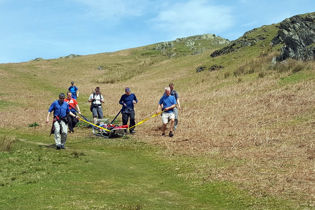 The walker is stretchered from the fell by rescuers. Photo: Cockermouth MRT The walker is stretchered from the fell by rescuers. Photo: Cockermouth MRT