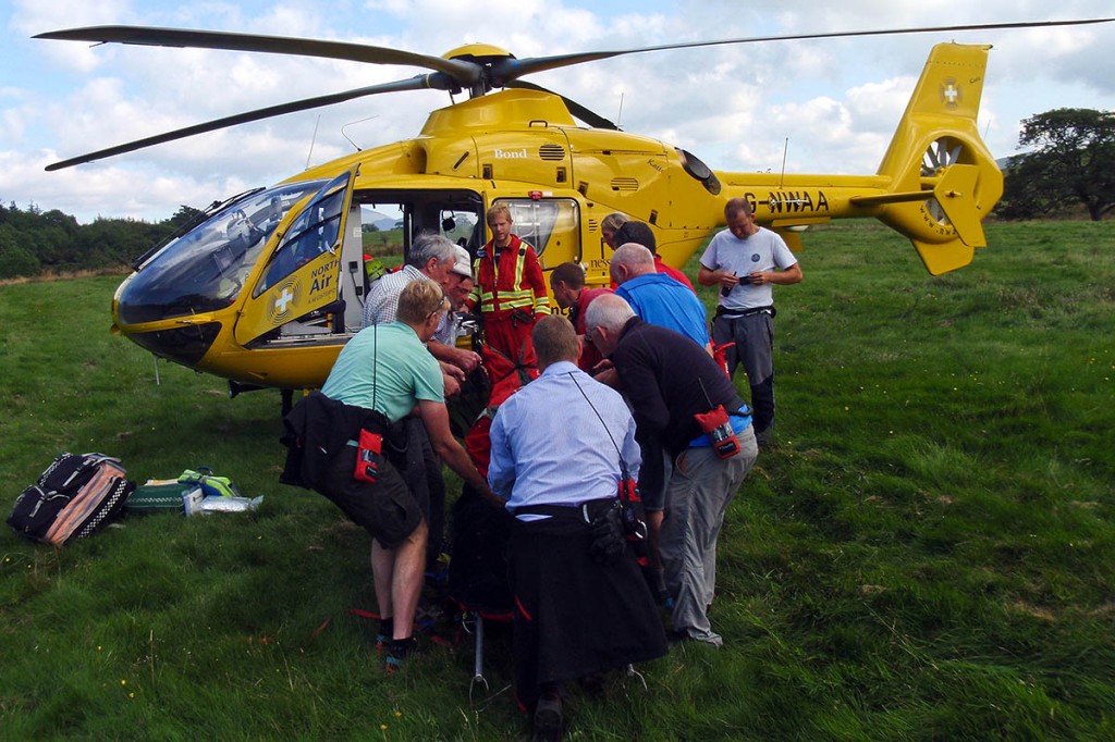 The injured mountain biker is stretchered to the air ambulance. Photo: Cockermouth MRT