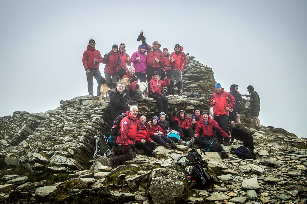 Lee Harris and Lesley McCartney, back centre, celebrate their successful final ascent of the Old Man of Coniston with friends and colleagues from Coniston MRT Photo: No Routes Found
