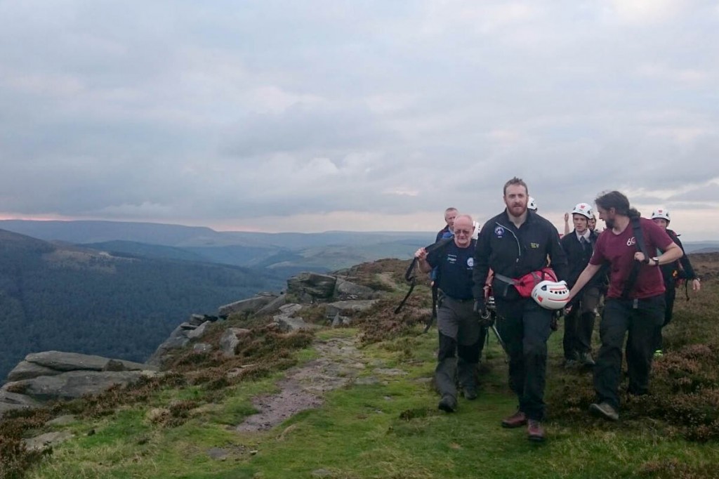 The team stretchers the injured climber from the crag. Photo: Edale MRT