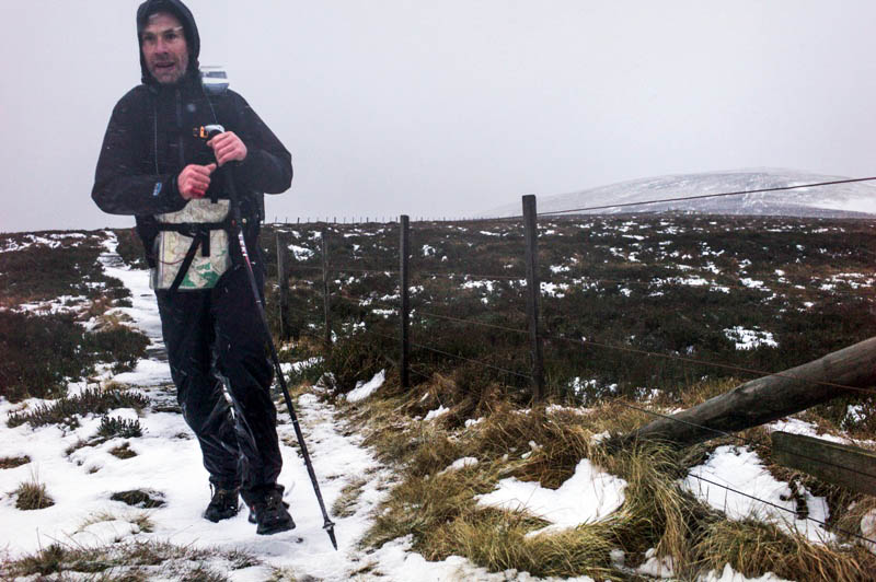 Eoin Keith moves through strong winds and snow on the Pennine Way, after descending Russell's Cairn in the Cheviot Hills. Photo: Chris Strickland