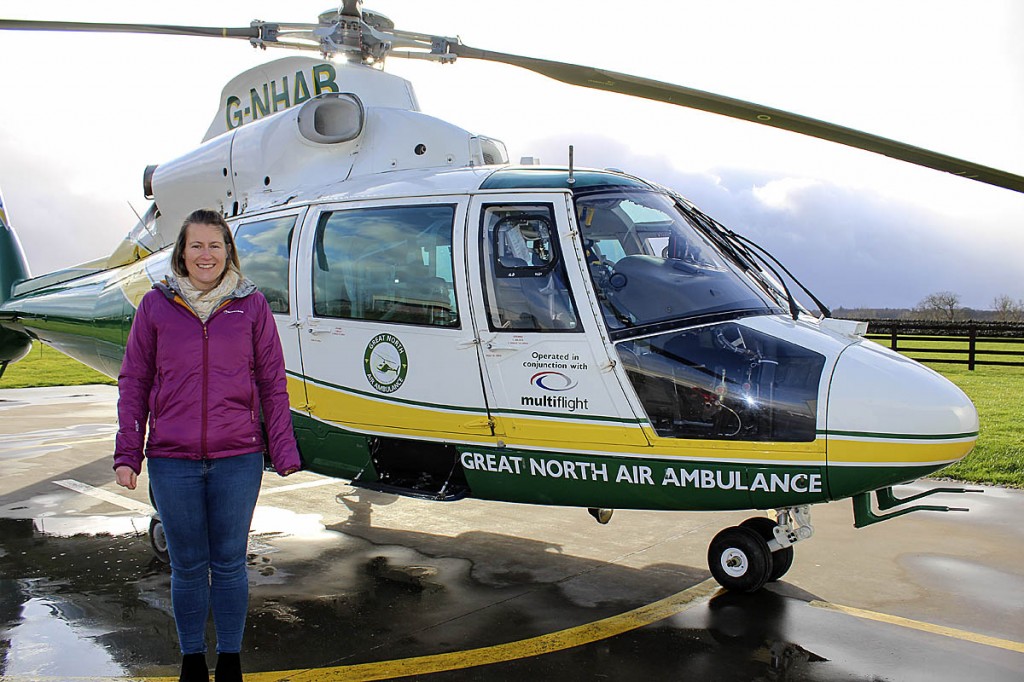 Nicky Ridley stands by the helicopter that came to her aid. Photo: GNAAS