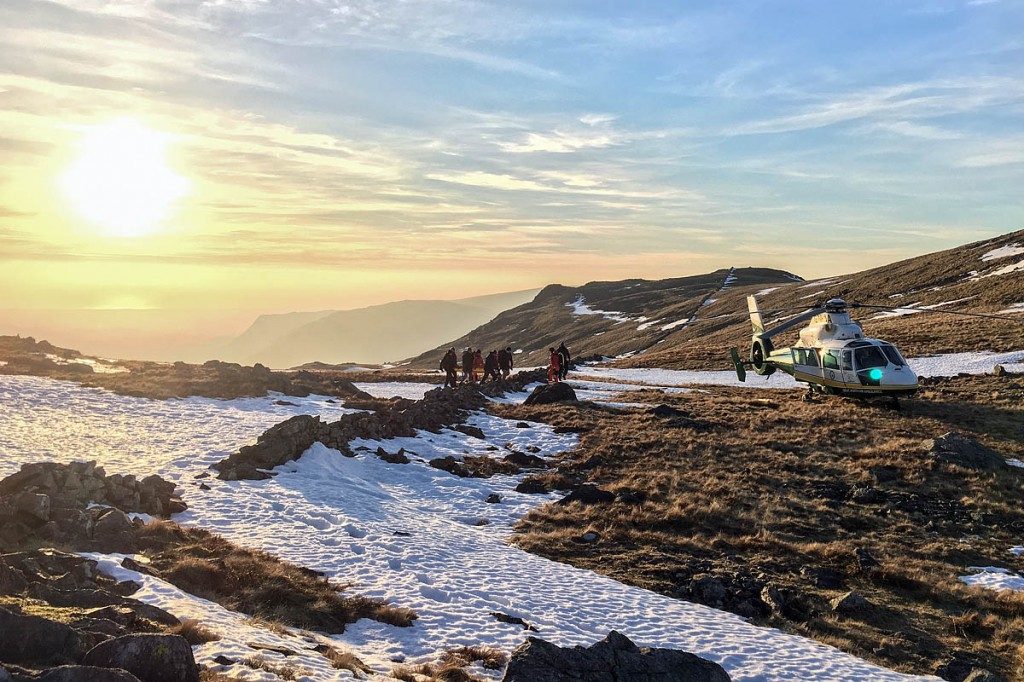 Rescuers stretcher the injured walker to the air ambulance. Photo: GNAAS Rescuers stretcher the injured walker to the air ambulance. Photo: GNAAS