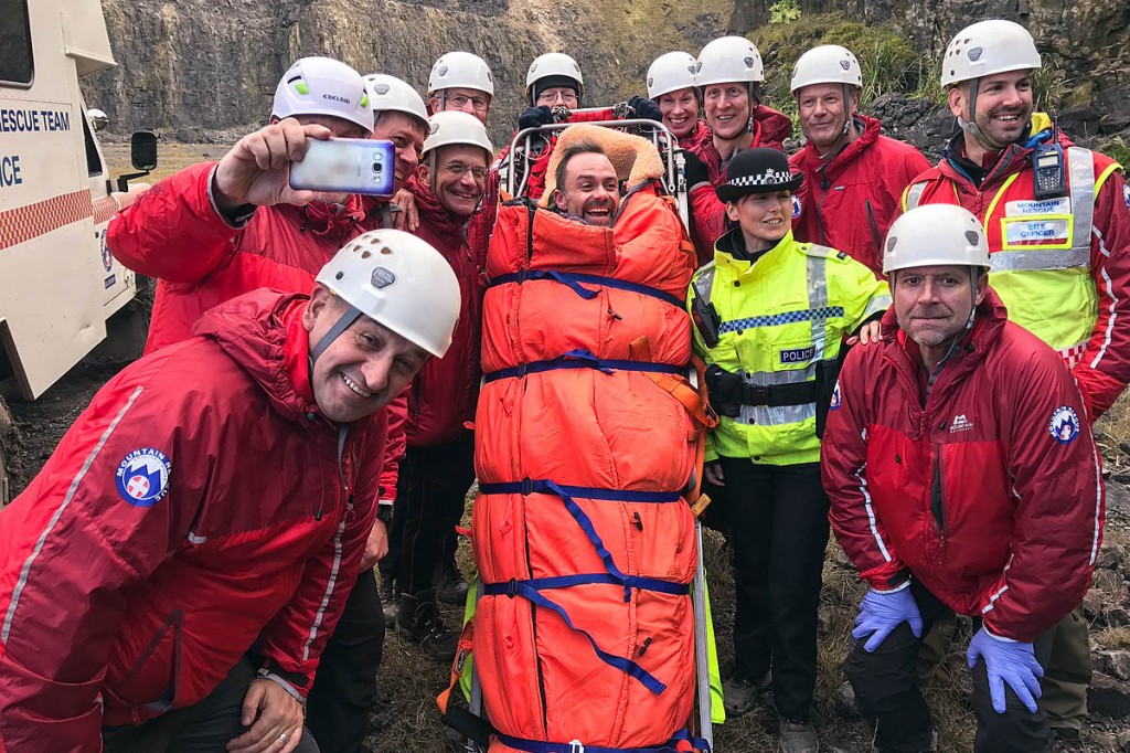 Glossop team members with actor Daniel Brocklebank in their stretcher. Photo: Glossop MRT Glossop team members with actor Daniel Brocklebank in their stretcher. Photo: Glossop MRT