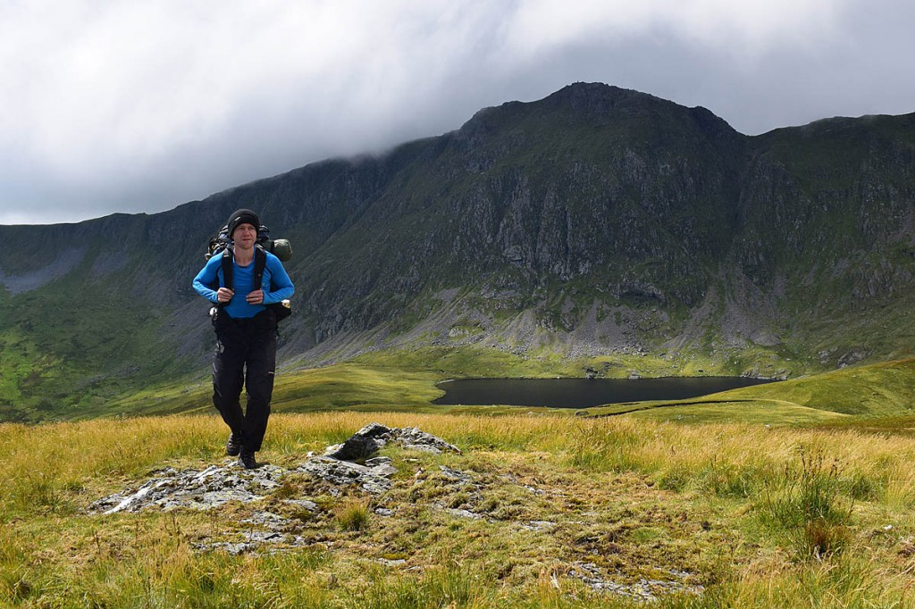The challenge walker hiking in Wales, with Aran Fawddwy in the background