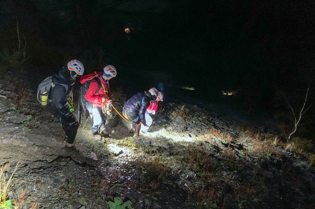 Rescuers help the walkers down the slope on Barf. Photo: Keswick MRT
