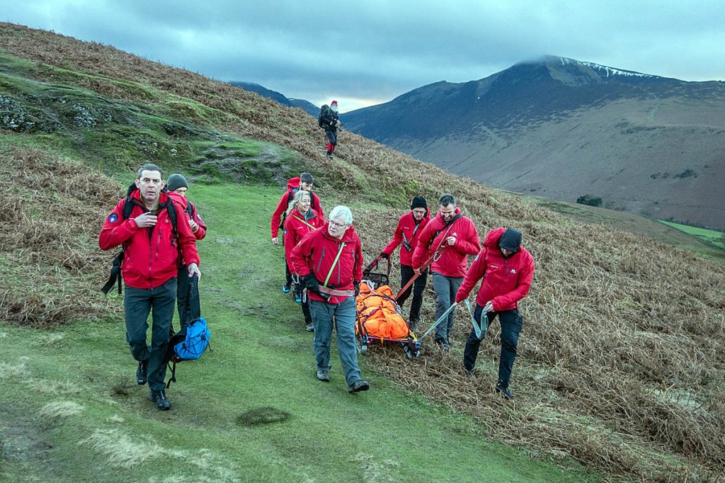 Rescuers sledge the stretcher down Barrow. Photo: Keswick MRT Rescuers sledge the stretcher down Barrow. Photo: Keswick MRT