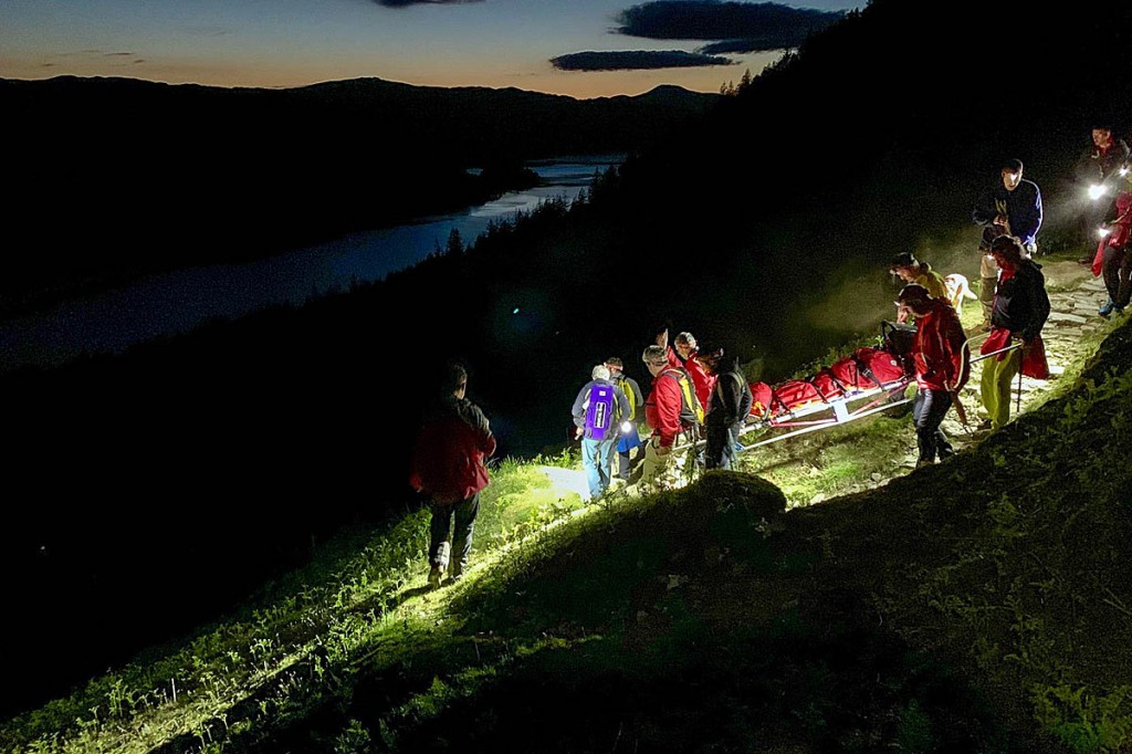 Rescuers stretcher the injured walker off the fell. Photo: Keswick MRT Rescuers stretcher the injured walker off the fell. Photo: Keswick MRT