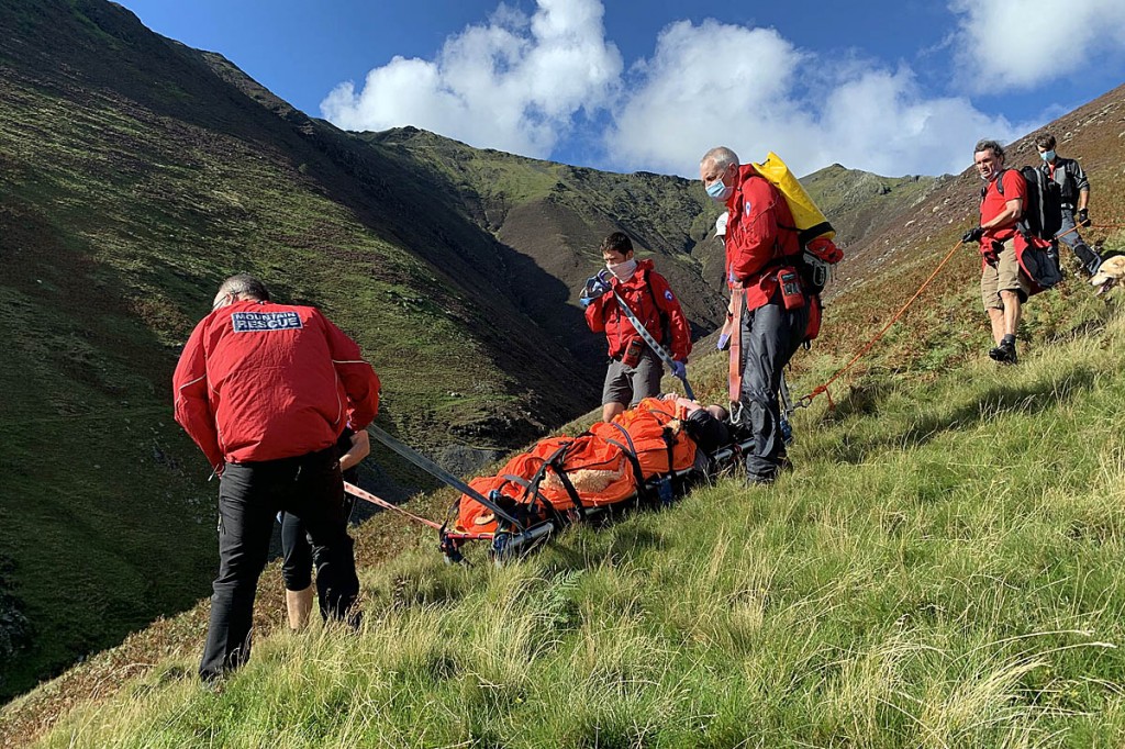 Rescuers stretcher the injured walker from Hall's Fell Ridge. Photo: Keswick MRT