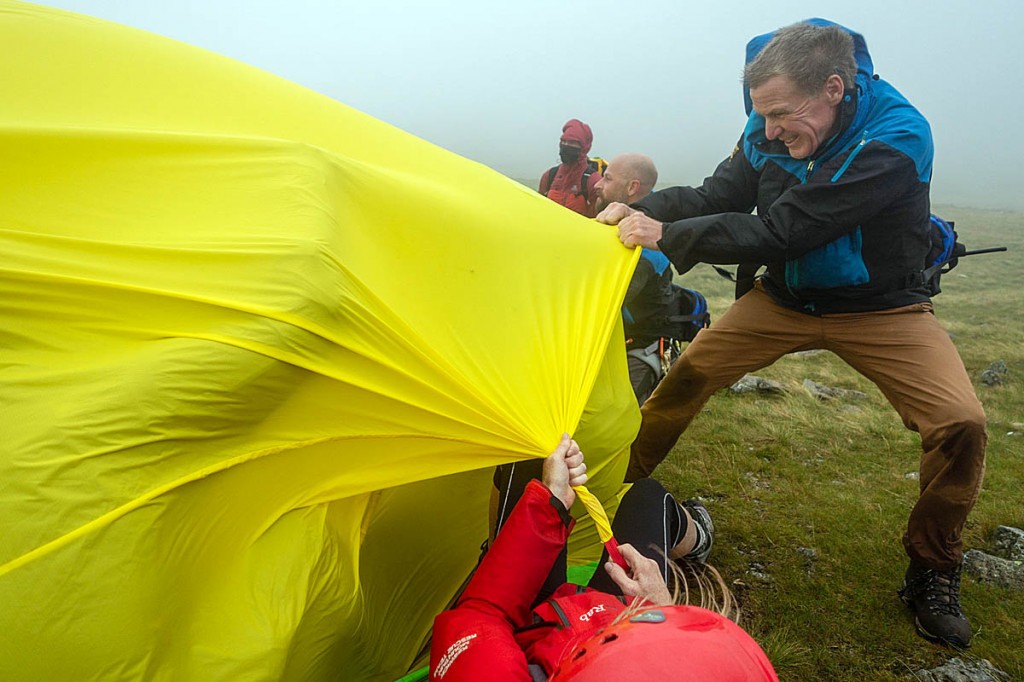 Rescuers battle to keep the shelter in place as gales lash the fell. Photo: Keswick MRT