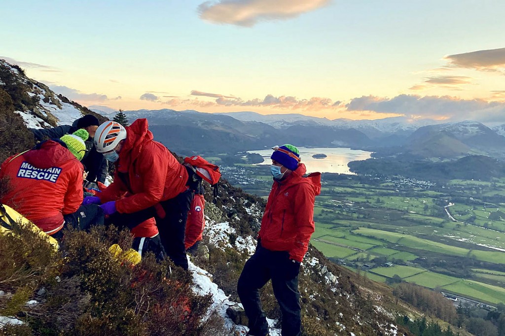 Team members tend to the injured walker on Carl Side. Photo: Keswick MRT Team members tend to the injured walker on Carl Side. Photo: Keswick MRT