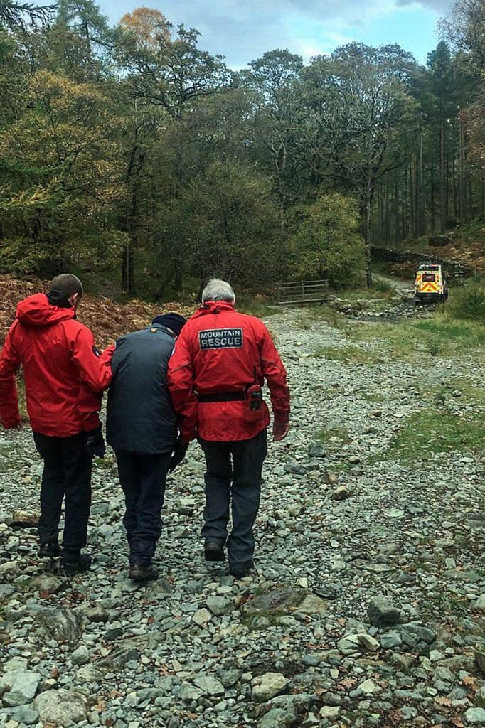 Rescuers help the injured walker to a team Land Rover. Photo: Keswick MRT Rescuers help the injured walker to a team Land Rover. Photo: Keswick MRT