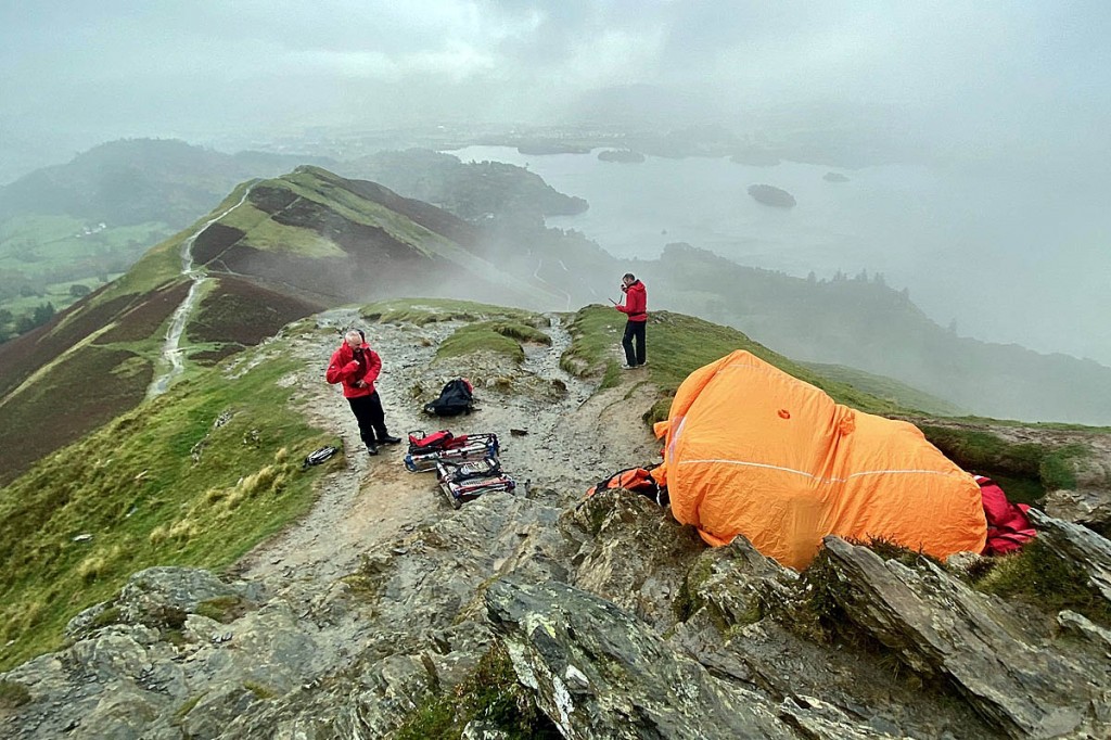 Rescuers treat the injured walker in an emergency shelter on Cat Bells. Photo: Keswick MRT