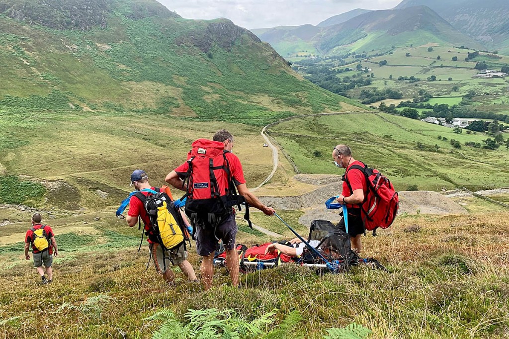 Rescuers stretcher the injured woman from the fell. Photo: Keswick MRT Rescuers stretcher the injured woman from the fell. Photo: Keswick MRT