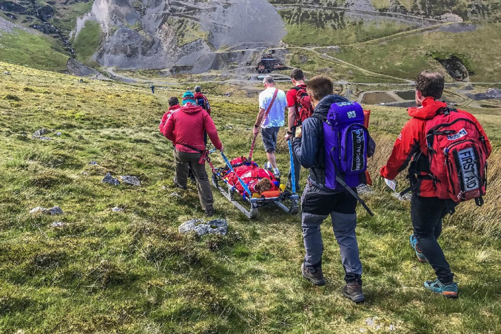 Rescuers stretcher the injured walker from the fell. Photo: Keswick MRT Rescuers stretcher the injured walker from the fell. Photo: Keswick MRT