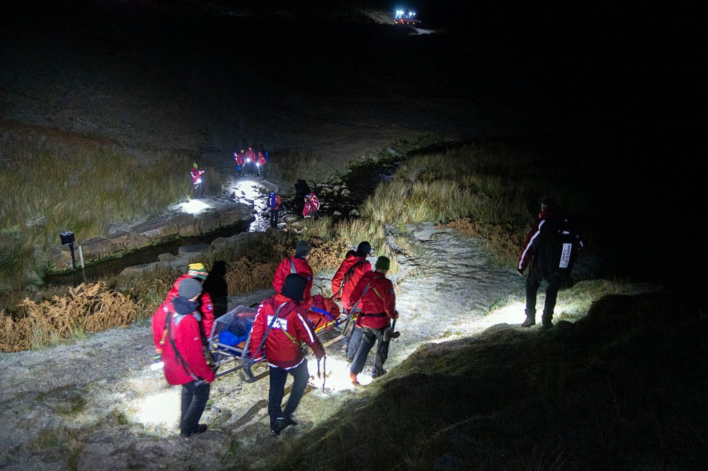 Rescuers prepare to stretcher the walker across the beck. Photo: Keswick MRT