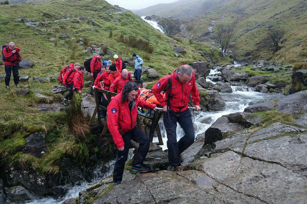 Rescuers stretcher the woman down Grains Gill after her fall. Photo: Keswick MRT Rescuers stretcher the woman down Grains Gill after her fall. Photo: Keswick MRT