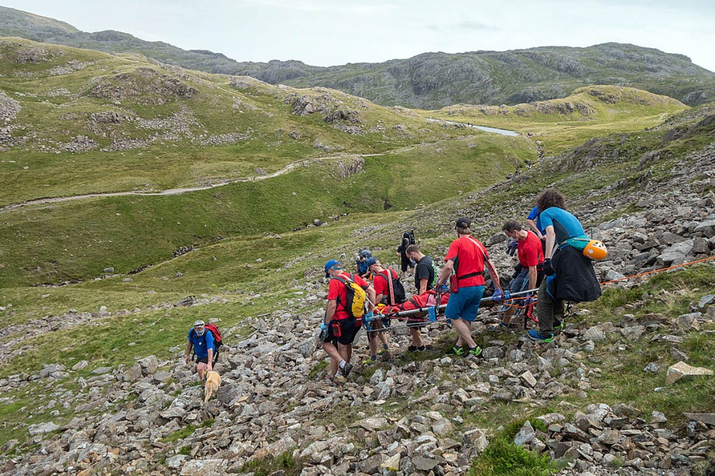 The injured man is stretchered down the boulder-strewn fellside. Photo: Keswick MRT The injured man is stretchered down the boulder-strewn fellside. Photo: Keswick MRT