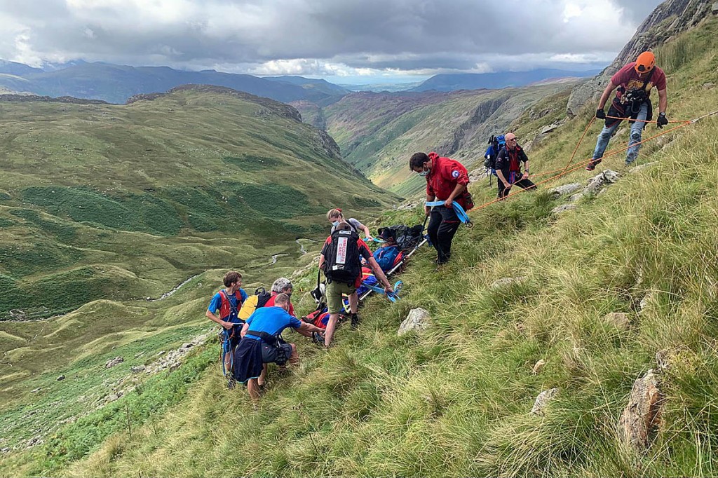 Rescuers stretcher the injured walker down from Greenup Edge. Photo: Keswick MRT