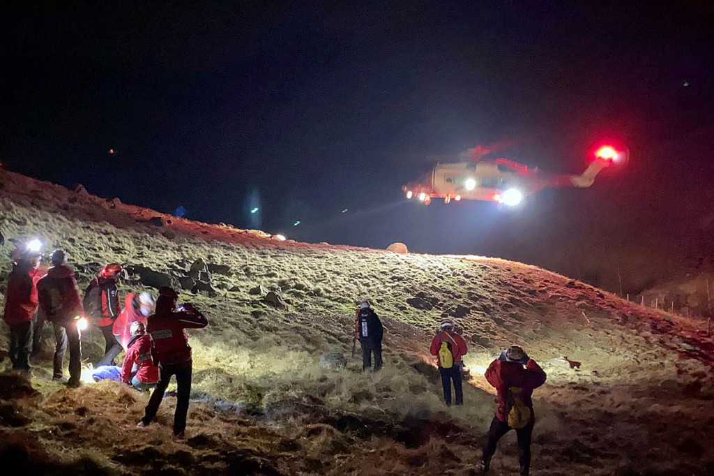 Rescuers and the Coastguard helicopter at the scene in Greenup Gill. Photo: Keswick MRT