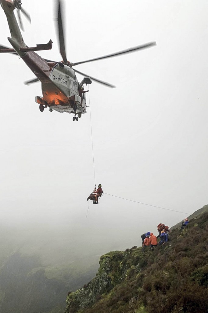 The injured walker is winched into the Coastguard helicopter. Photo: Keswick MRT The injured walker is winched into the Coastguard helicopter. Photo: Keswick MRT