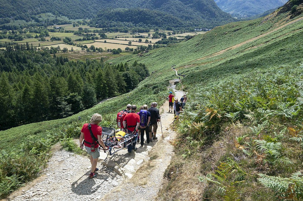 Team members help the walker from Hause Gate after the incident. Photo: Keswick MRT